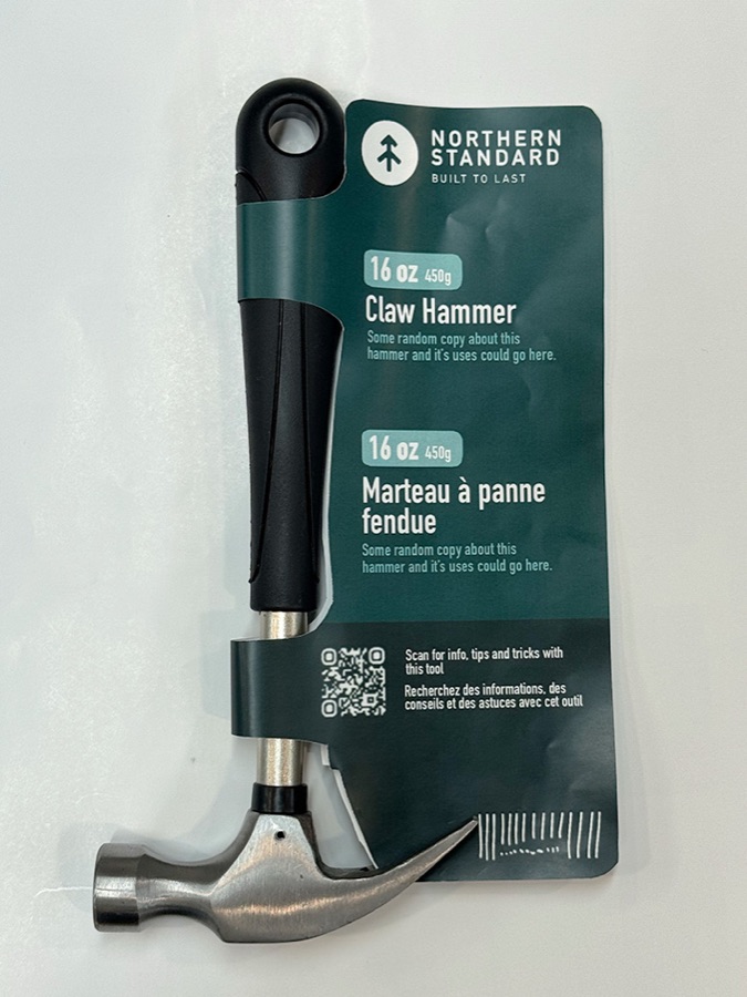Third printed prototype with dark green topographic pattern and product information arranged around a claw hammer