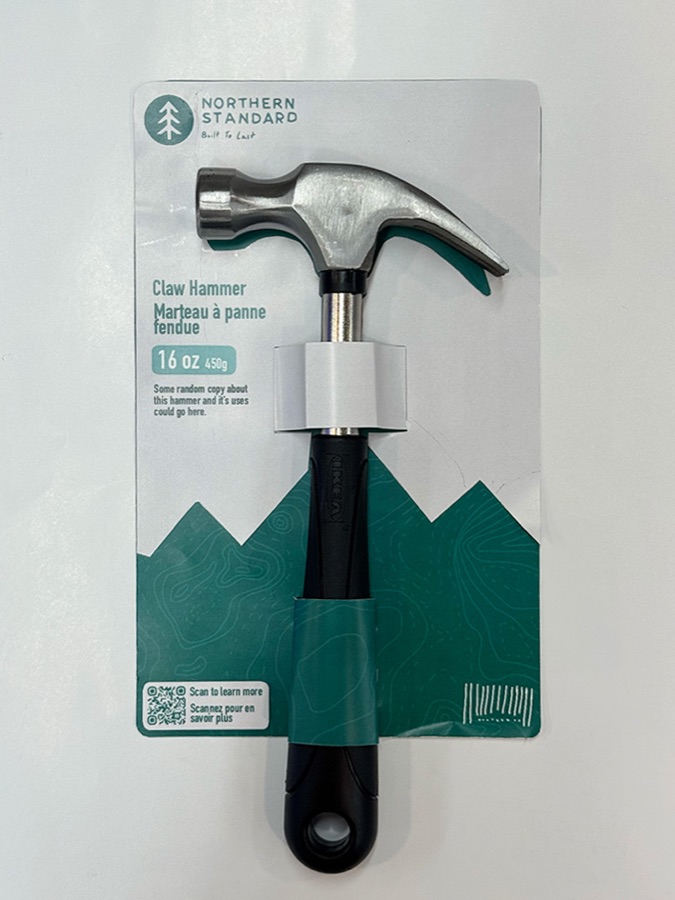Second printed prototype with mountain shapes framing a vertically arranged claw hammer